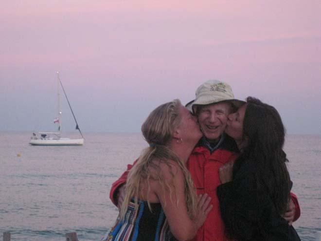 Trixie, Vern and Ashly Myers on the Pamplonne beach with their Dufour 455 in the background. © Trixie Slater